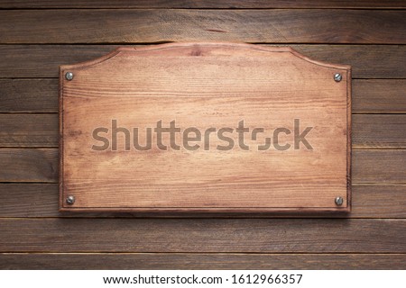 nameplate or wall sign at  wooden background texture surface, with screws