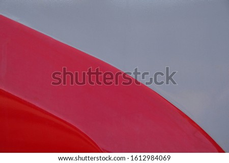 red and gray metal panels of locomotive, painted sheet metal