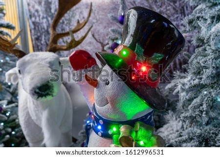 A snowman and reindeer christmas decoration on display