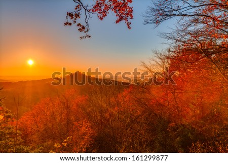Lovely Autumn Landscape Panorama Picture of Northern Bavaria, Germany with colorful trees in the sunset