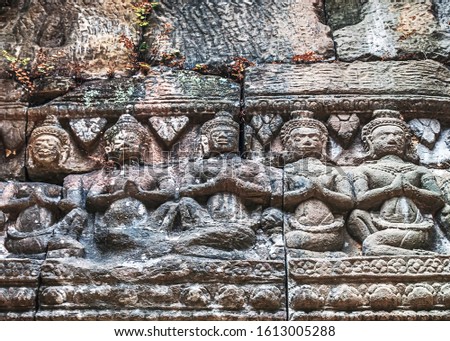 detail of ancient stone bas-relief carvings on the wall background texture - complex Angkor wat Cambodia.