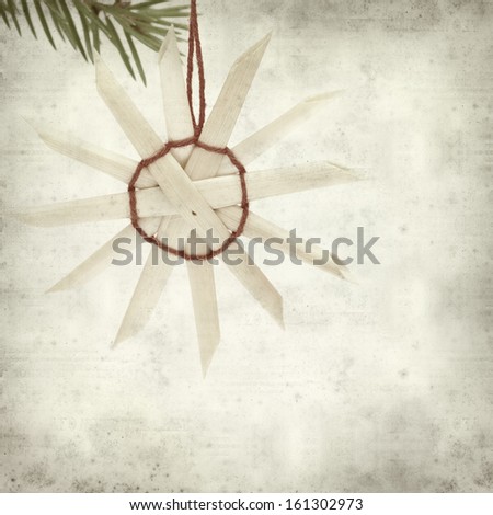 textured old paper background with traditional straw Christmas ornaments