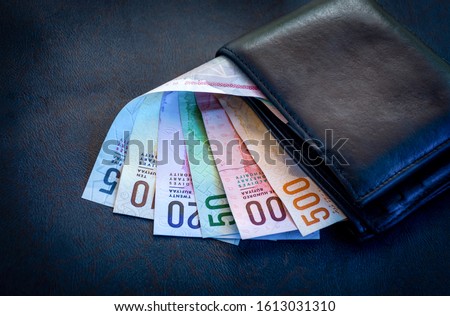 Maldives Currency note Rufiyaa in the wallet on a leather table background, colorful currency note with purse, Saving money concept image