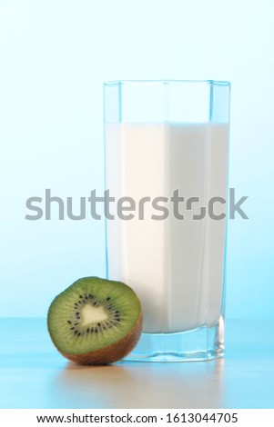 a ahlf kiwi and a glass of milk Royalty-Free Stock Photo #1613044705