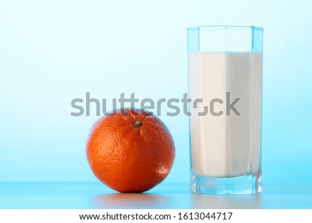 a orange fruit and a glass of milk Royalty-Free Stock Photo #1613044717