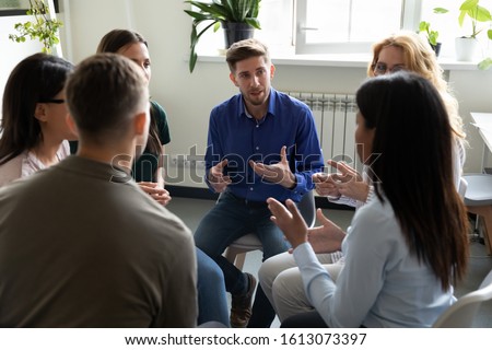 Diverse workgroup solve current issues, discuss common project, taking part in team building talk. Psychologist counselor therapist speak at group therapy session, psychotherapy meeting rehab concept Royalty-Free Stock Photo #1613073397