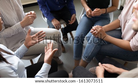 Top close up view in circle sit people, corporate teambuilding activity solve issues talk think together or alcohol rehab addiction treatment, twelve-step program, physical, mental, spiritual concept Royalty-Free Stock Photo #1613073511
