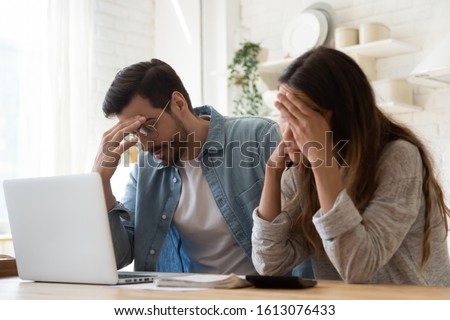 Head shot stressed young family couple feeling disappointed by high utility bills, money loss. Unhappy nervous married spouse received debt mortgage notification, checking financial documents. Royalty-Free Stock Photo #1613076433