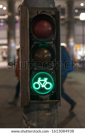 traffic light for cyclists in green in a german city at night
