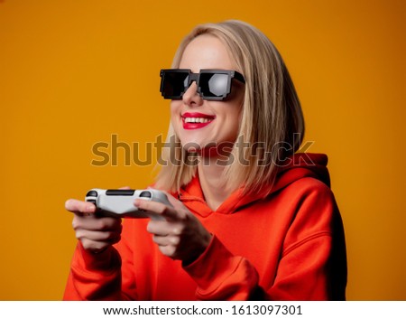 girl in sunglasses keen plays with a joystick