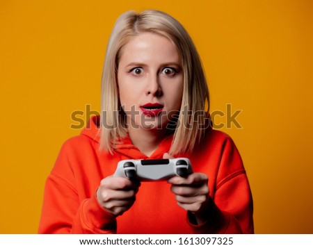 blonde girl keen plays with a joystick