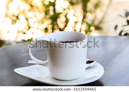 colorful white ceramic cup on wooden table and bokeh background,Beautiful foam