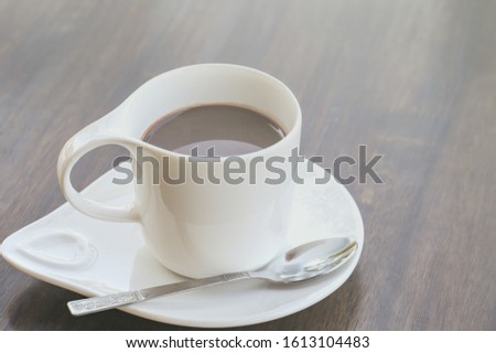 Top view Coffee with white cup on wood table. Coffee with beautiful cup of cocoa with chocolate on wooden. Beautiful foam, White ceramic cup, place for text.