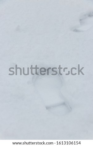 Footprints in fresh snow. Footsteps on white snow
