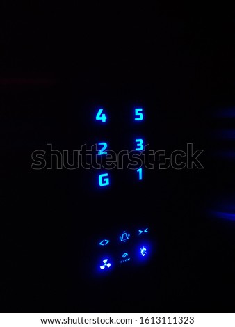 blue LED number panel of an elevator/lift with special buttons for bell and fan 