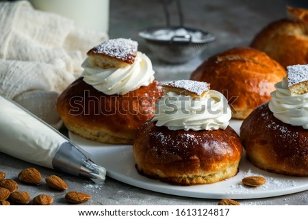 Semla or semlor, vastlakukkel, laskiaispulla is a traditional sweet roll made in various forms in Sweden, Finland, Estonia, Norway, Denmark, especially Shrove Monday and Shrove Tuesday       Royalty-Free Stock Photo #1613124817