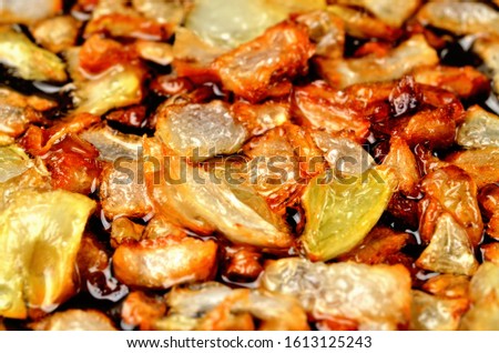 Golden chopped onion fried in oil. Close-up