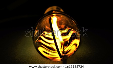 Retro led light bulb spiral filament on a dark background macro photography.