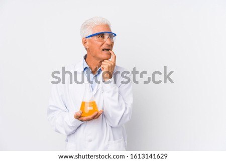 Mature chemical man isolated relaxed thinking about something looking at a copy space.