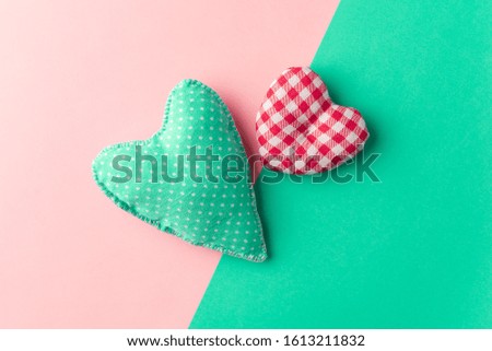 Handmade textile mint and red heart on color block background, minimalistic Valentine's day symbol