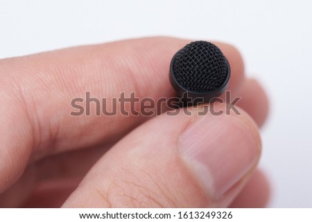 Macro of lavalier microphone isolated on white background