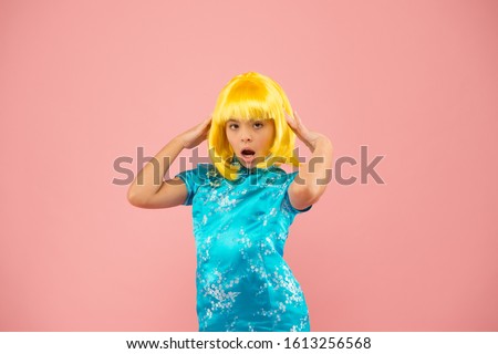 Girl yellow wig. Cosplay character concept. Japanese style. Eastern trends for teens. Hobby and entertainment. Pop culture. Anime fan. Child cute cosplayer. Anime emotional expression. Anime admirer.