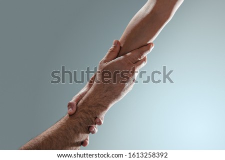 Tho hands holding, help, assist, support and trust concept.