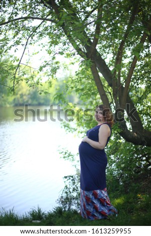 happy pregnant beautiful girl with curly  ginger hair