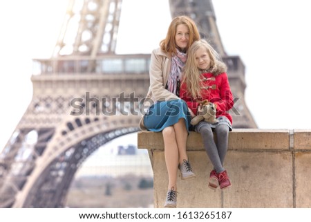 happy travel. Mom and daughter on the background of the Eiffel Tower in Paris. France 

