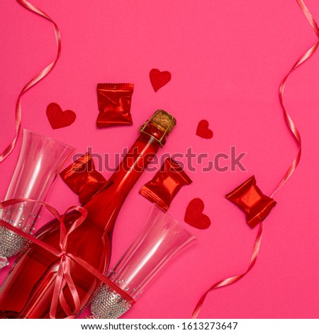 Holiday set for Valentine's Day. champagne, sweets and hearts on a pink background.