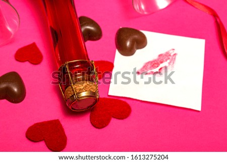 Holiday set for Valentine's Day. champagne, sweets and hearts on a pink background.