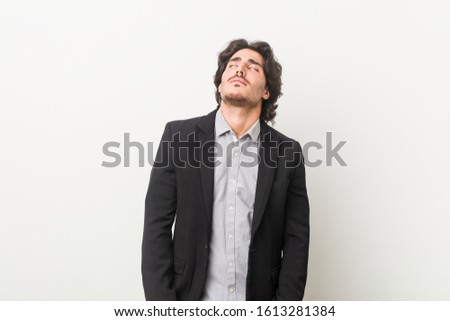 Young business man against a white background tired of a repetitive task.