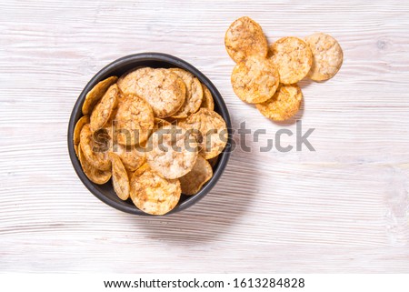 Top view pile of organic, crispy, baked, whole grain rice chips  Royalty-Free Stock Photo #1613284828