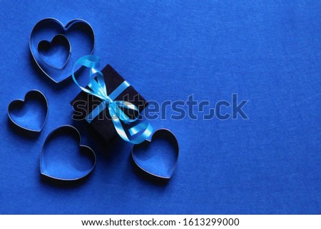 many hearts and gift  in trendy color of year 2020 on classic blue background. Copy space.