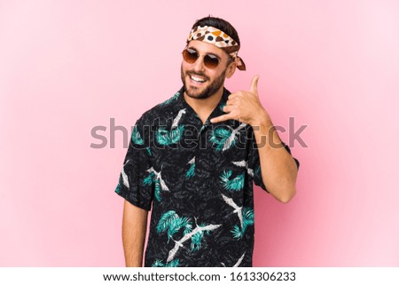 Young hipster man isolated showing a mobile phone call gesture with fingers.