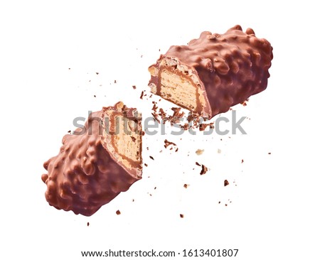Chocolate bar with caramel flying in the air isolated on white background. High resolution image. Food levitation concept.