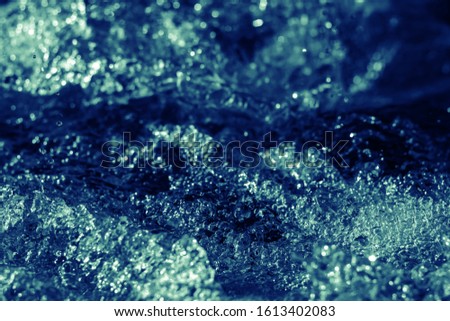 cold blue frozen motion of fresh splashing water of the riverbed