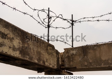 barbed wire fence on the sky background