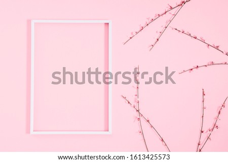 Beautiful flowers composition. Blank frame for text, pink flowers on pastel pink background. Valentines Day, Easter, Birthday, Mother's day. Flat lay, top view, copy space