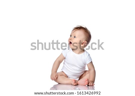 Infant child baby boy kid with blue eyes sitting in white body t-shirt with blank copy text space isolated on a white background. 