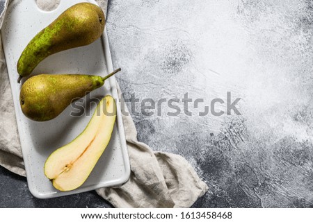 Pears on Kraft paper. Seasonal ripe pears. Gray background. Top view. Space for text
