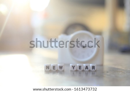 New Year word concept with block and clock. selective focus