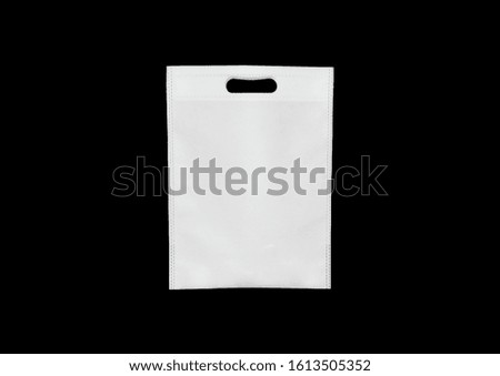 Die-Cut White Color Fabric eco Shopping Bag isolate on Black color background. Use me every time i am eco bag. world Environment Day. PP Non Woven Bag. Save earth with friendly products. bag Mock-up Royalty-Free Stock Photo #1613505352