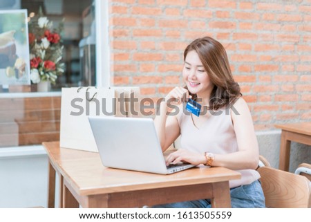 Technology, Online shopping, Digital banking, home lifestyle concept, a beautiful Smiling Asian woman with laptop credit card at home for business payment, career, e-commerce trading retail