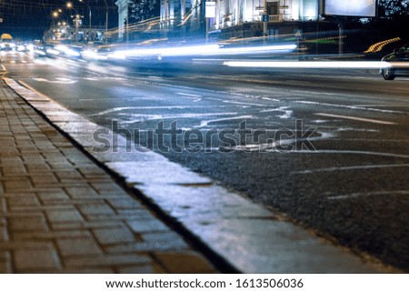 street traffic at night. bright light trails illuminating the road. long exposure effect
