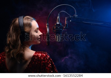 Banner for vocal lessons and music. A professional singer sings into a studio microphone. Screensaver for karaoke and vocal mastery. Music schools and music training