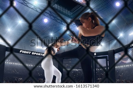 MMA female fighters on professional ring. 