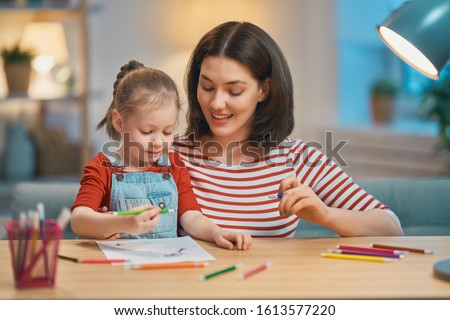 Happy family. Mother and daughter drawing together. Adult woman helping to child girl. Royalty-Free Stock Photo #1613577220