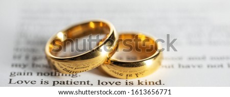 Two golden wedding rings on Holy bible book close up