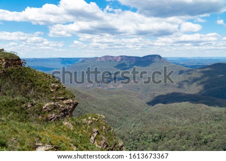 Panoramic Blue Mountains Australia. Dramatic views of peaks, rock, valley, landscape, green rainforest jungle. Adventure, freedom, fun concepts. Tourist mountain trek. Shot in Sydney, NSW.